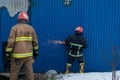 Firefighters work on an fire of building using a metal cutter rescue tool during a fire. fire extinguish Royalty Free Stock Photo