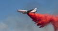 Airplane fighting forest fire with water bombing Royalty Free Stock Photo
