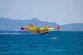 Firefighting airplane taking water from sea Royalty Free Stock Photo