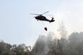 Firefighting helicopter flies over burned land