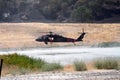 Firefighting helicopter refills water bucket