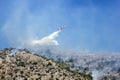 Firefighting plane extinguishes a fire on the hillside . Greece. Royalty Free Stock Photo