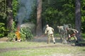 Firefighting team training: firemen in protective ensembles fighting fire in forest