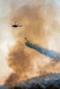 Firefithing helicopter dumps water on forest fire