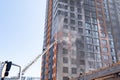 Fireman climbing a ladder with water hose for extinguish fire