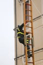 Fireman climbs above the staircase Royalty Free Stock Photo