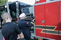 Fireman demonstrates equipment on firetruck just blessed