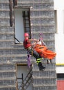 fireman during an exercise carries the stretcher with the climbing rope Royalty Free Stock Photo