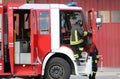 Fireman exits the truck running to put out the fire Royalty Free Stock Photo