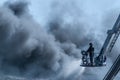 A fireman fighting a warehouse fire