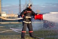 Fireman with fire extinguishing foam spraying hose Royalty Free Stock Photo