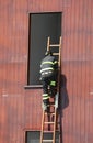 fireman at the fire station with wooden the ladder Royalty Free Stock Photo