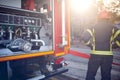 Fireman firefighter in action standing near a fire truck.  Attack, danger Royalty Free Stock Photo