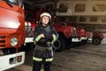 Fireman firefighter in action standing near a firetruck. Emer