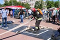 A fireman in a fireproof suit and a helmet holding a fire hose at a fire sport competition. Minsk, Belarus, 08.07.2018