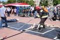 A fireman in a fireproof suit and a helmet holding a fire hose at a fire sport competition. Minsk, Belarus, 08.07.2018