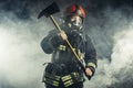 Fireman with hammer don`t afraid of danger and fire