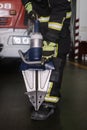 Fireman holding a pair of pneumatic scissors in a fire station Royalty Free Stock Photo