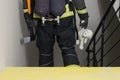 Fireman holding plush toy, back view