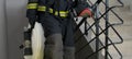 Fireman, holding water handling equipment, barrel and hoses