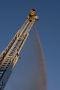 Fireman on Ladder Truck Spray Water on Fire Royalty Free Stock Photo