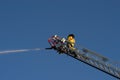 Fireman on Ladder Truck Spray Water on Fire Royalty Free Stock Photo