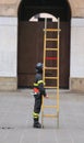 Fireman with wooden ladder Royalty Free Stock Photo