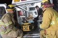 Fireman Looking At Patient And EMT Doctor