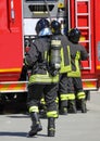 Fireman with oxygen tank and fire truck in the background