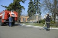 Fireman preparing firefighting equipment near firetruck before firefighting. Kyivska oblast, Ukraine