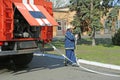 Fireman preparing firefighting equipment near firetruck before firefighting. Kyivska oblast, Ukraine