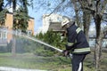 Fireman preparing firefighting equipment near firetruck before firefighting. Kyivska oblast, Ukraine