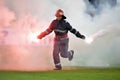 Fireman remove flares from the football pitch