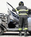 Fireman removes the door of a destroyed car after a car accident