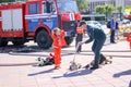 A fireman`s man is teaching a little girl in an ornery fireproof suit to run around with Belarus, Minsk, 08.08.2018 Royalty Free Stock Photo