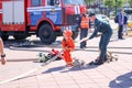 A fireman`s man is teaching a little girl in an ornery fireproof suit to run around with Belarus, Minsk, 08.08.2018 Royalty Free Stock Photo