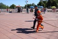 A fireman`s man is teaching a little girl in an ornery fireproof suit to run around with Belarus, Minsk, 08.08.2018 Royalty Free Stock Photo