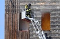 fireman with self-contained breathing apparatus with the oxygen cylinder in the destroyed building of the flames