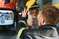 A fireman shows his work to his young son. A boy in a firefighter& x27;s helmet Royalty Free Stock Photo