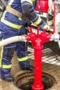 Fireman turns taps on the hydrant Royalty Free Stock Photo
