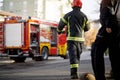 Fireman in uniform in front of fire truck going to rescue and protect. Emergancy servise concept