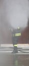 fireman uses a foam to extinguish a fire