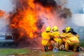 Fireman using water and extinguisher car is on fire,Firefighter using extinguisher and water from hose for fire fighting,burning c