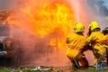 Fireman using water and extinguisher,fireman using water and extinguisher car is on fire,