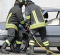 Firemen and a broken car on tafter the crash Royalty Free Stock Photo