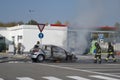 Firemen extinguishing a car fire