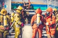 Firemen in firefighter uniform are checking their equipment after use.