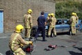 Firemen practice cutting an injured driver out of a wrecked car