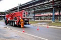 Firemen rescue workers in fireproof suits came to extinguish a fire in a fire truck and stretch the hoses in a large Royalty Free Stock Photo