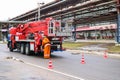 Firemen rescue workers in fireproof suits came to extinguish a fire in a fire truck and stretch the hoses in a large industrial Royalty Free Stock Photo